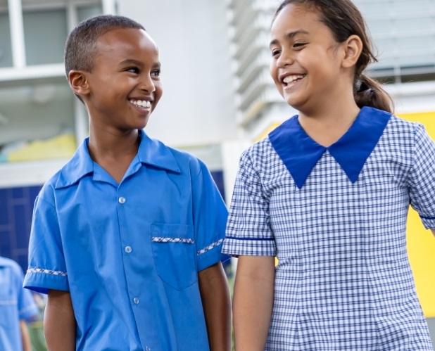 Two students walking in school grounds.