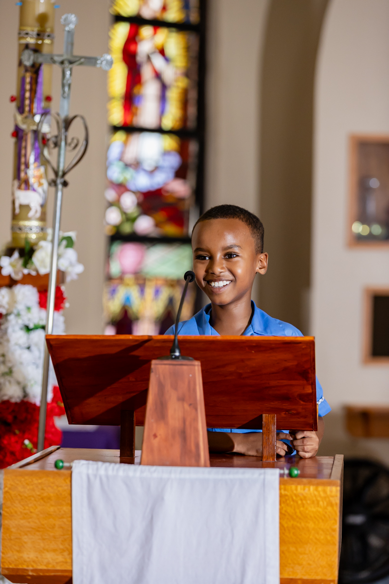 A young student standing at a podium in the church.